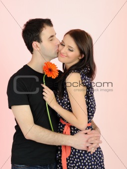 lovely romantic couple with flower embracing