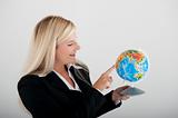 Beautiful business woman in a suit with globe figure