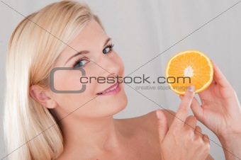young pretty woman with orange citrus fruit