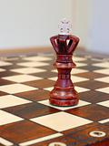 wooden chess figures on brown game board