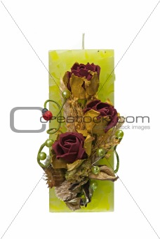 Large green candle with the flower decoration