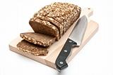 sliced wholemeal bread on kitchen board and knife 
