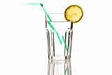 glass of water with green straw and lemon