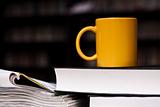 mug of coffee on the stack of books
