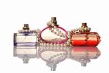 Perfume in a glass bottles and pearl beeds