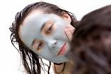 Girl putting on a mud mask