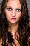 Sensual girl with long brown hair and expressive blue eyes
