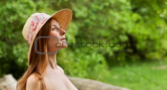 Young beautiful girl with hat posing outdoor