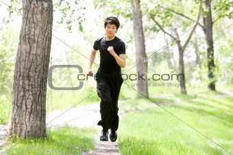 Portrait of man running in a park