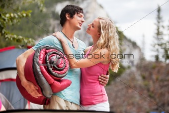 Romantic couple with sleeping bag while camping