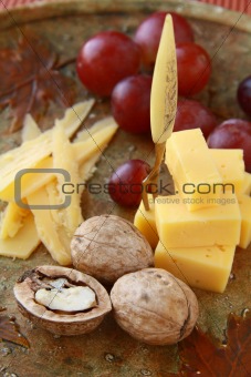 cheese plate with grapes and walnuts