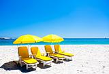 Four yellow beach chairs