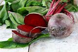 young, fresh organic beets with green leaves on the table