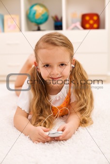Little girl listening to portable music device