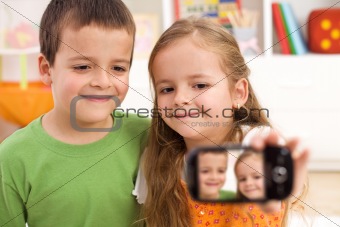 Say cheese - kids taking a photo of themselves