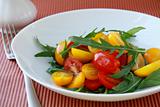 salad with arugula and cherry tomatoes on a striped background