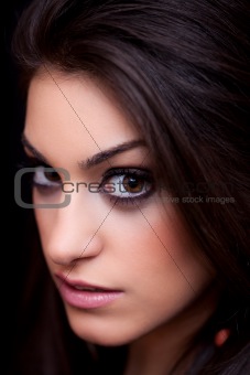 Portrait of a beautiful young woman, close up, on black backgrou