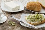 roll with cream cheese and sprouts