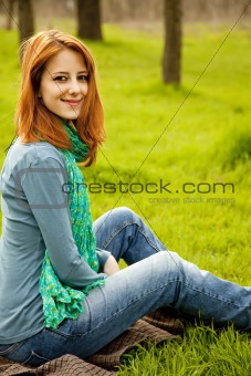 Beautiful red-haired girl sitting 