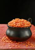 pot of red lentils in a red wooden board