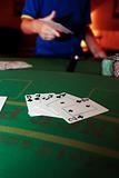 poker player throwing in loosing hand of cards