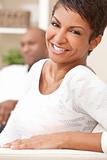 Happy African American Woman Couple Sitting At Home