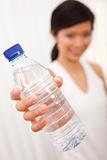 Asian Chinese Girl Holding Bottle of Pure Water to Camera