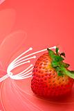 single fresh red strawberry on red background