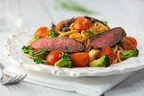Rustic spaghetti with beef strips and vegetables