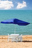 Table, chairs and parasol on  the beach