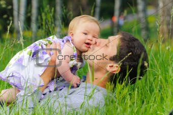 Happy father with daughter resting in the grass