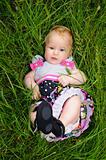 A beautiful little girl lying in the grass