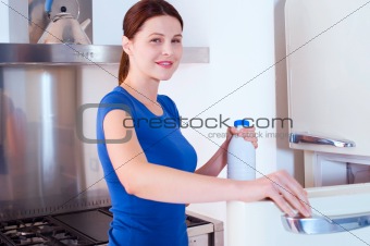 woman opening the refrigerator with milk bottle