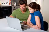 couple in the kitchen with laptop