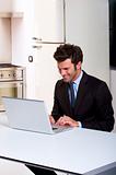 man in the kitchen with laptop