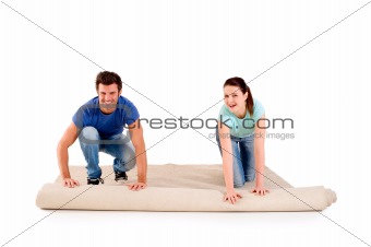 couple unrolling a carpet