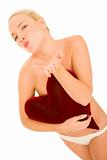 naked woman with heart-shaped pillow