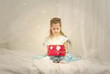 Little girl with shining red box