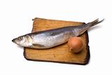 Herring with onion on old wooden board
