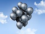 silver balloons on a blue sky