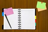 open notepad and colored memo with pen on wood background