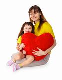 Mom and daughter with a toy heart in hands