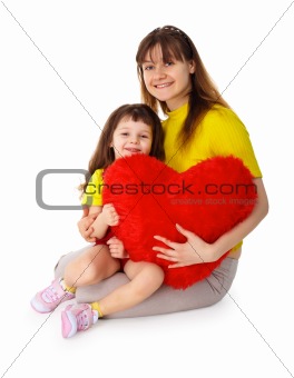 Mom and daughter with a toy heart in hands