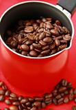 Fresh aromatic coffee beans in a metal coffee pot