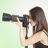 a young female photographer with a professional camera 