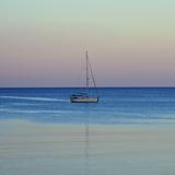 sailboat reflected on sea water