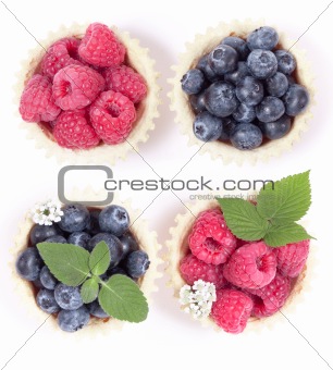 Raspberries and blueberry and blueberries in a waffle basket