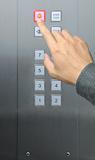 businessman hand press emergency  button in elevator