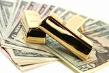 Gold bullion on dollar bills