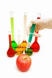 Hand injecting chemical into apple isolated on white